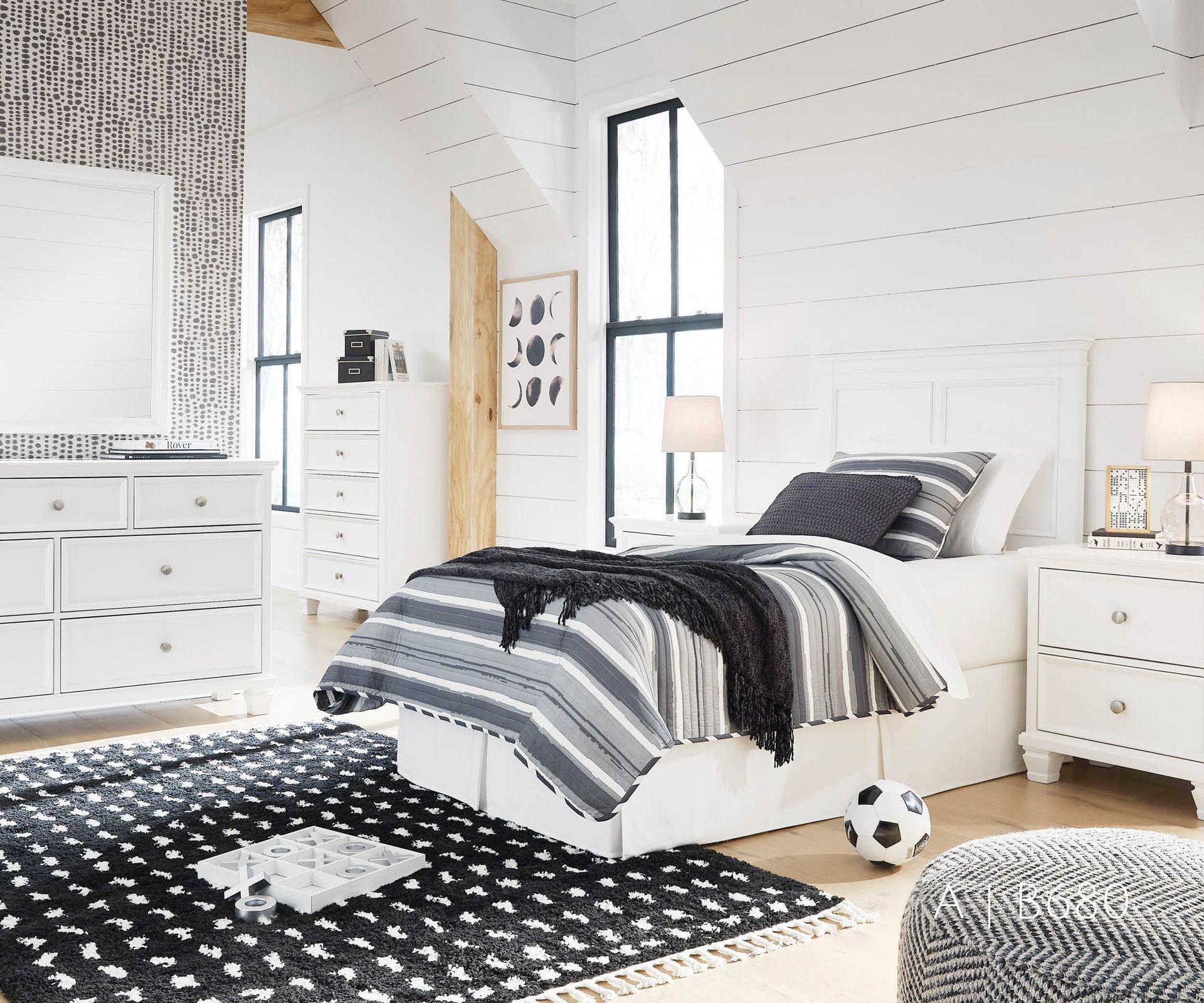 White bedroom with a bed, dresser, rug, and window.
