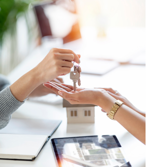 Photo of manager giving keys to tenant