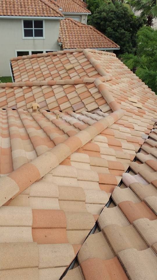 Clay tile roof with varying shades of beige and orange, angled view.