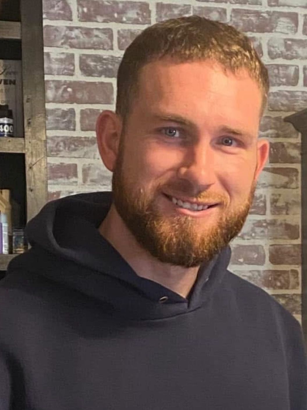 Man with beard and black sweatshirt smiling