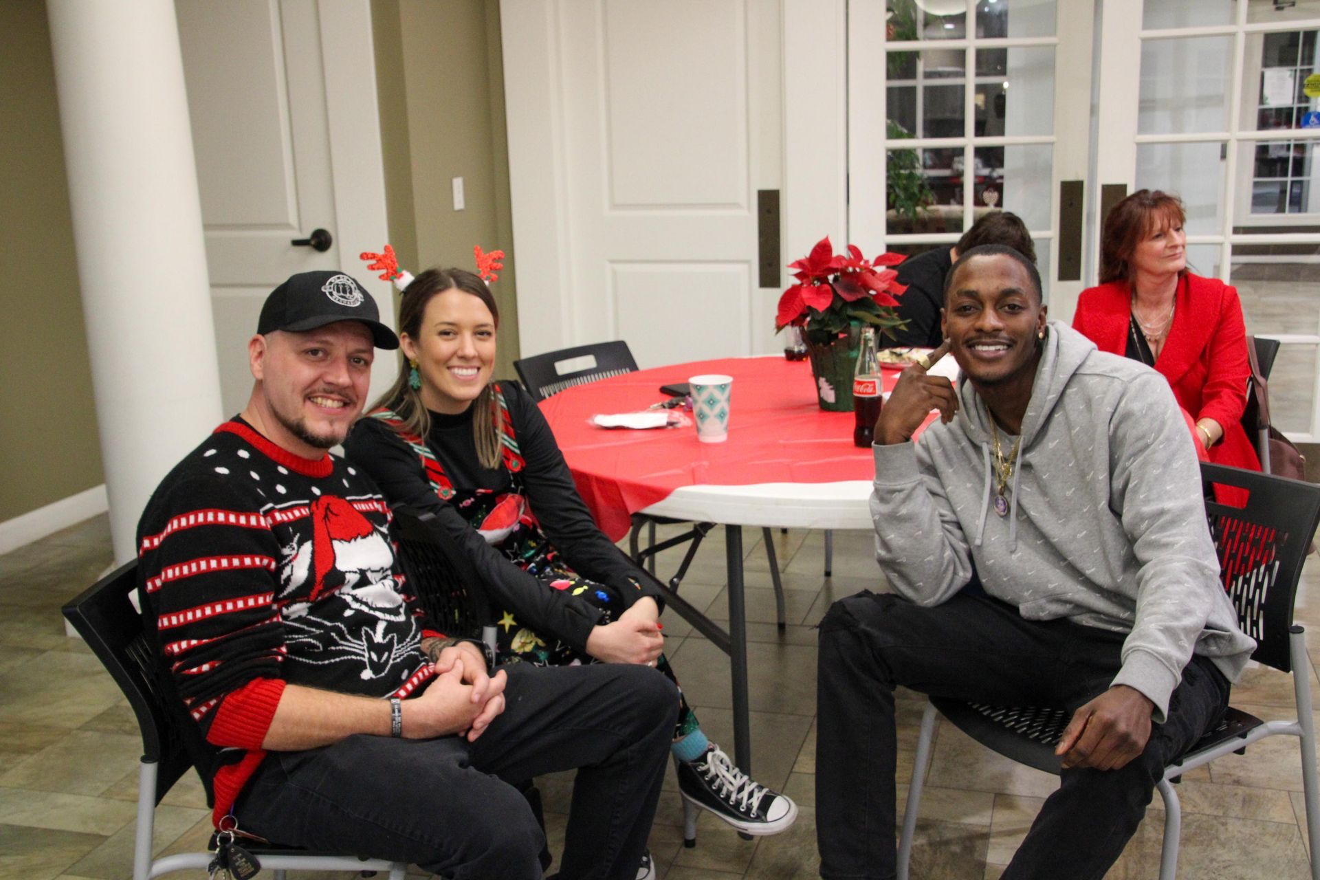 A group of people are sitting around a table in a room.