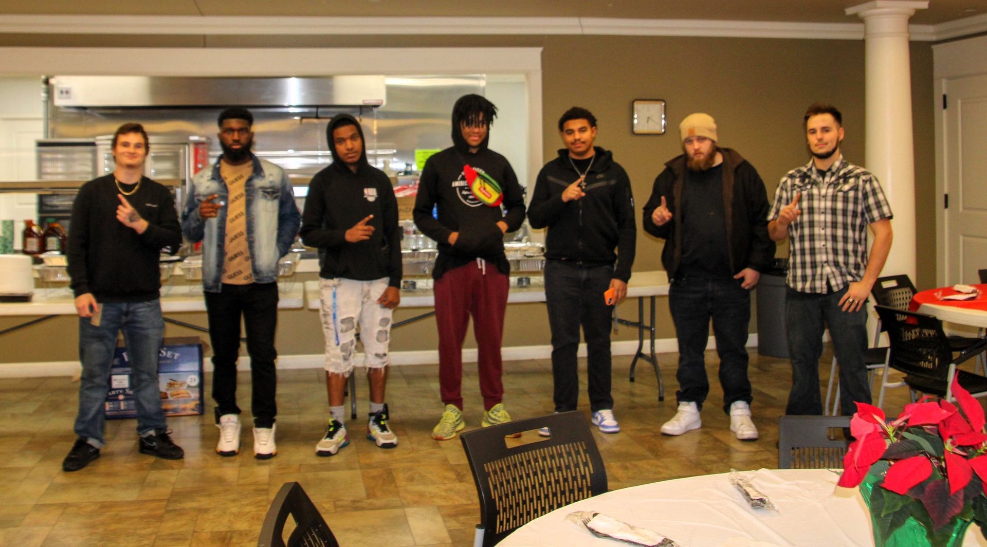 A group of young men are standing next to each other in a room.