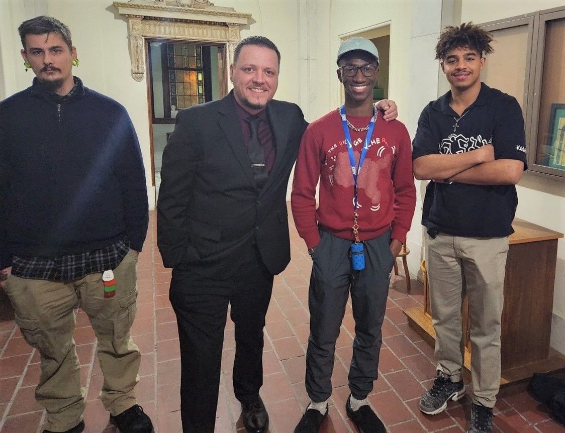 A group of men are posing for a picture in a room