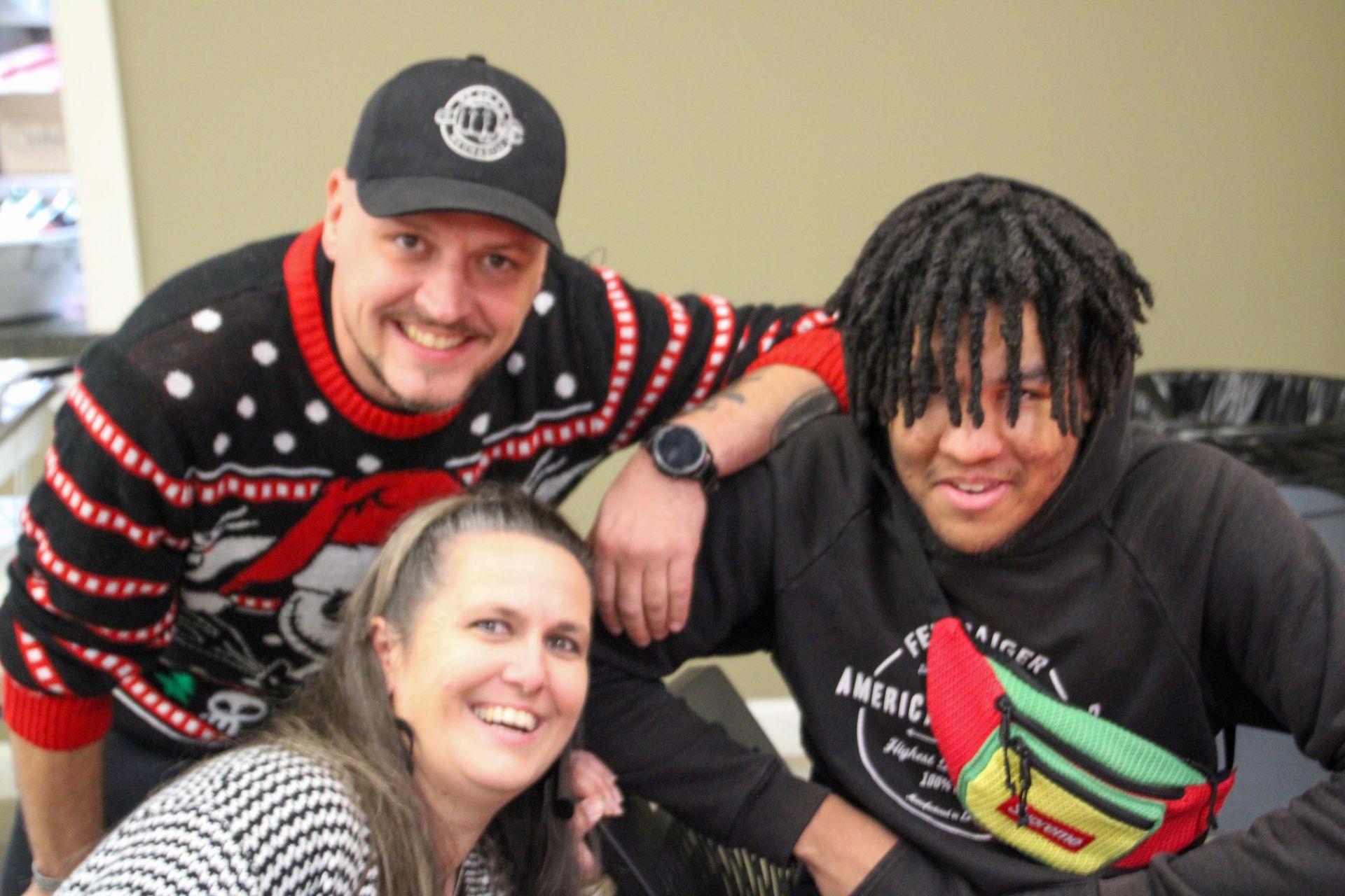 A man , a woman and a boy are posing for a picture.
