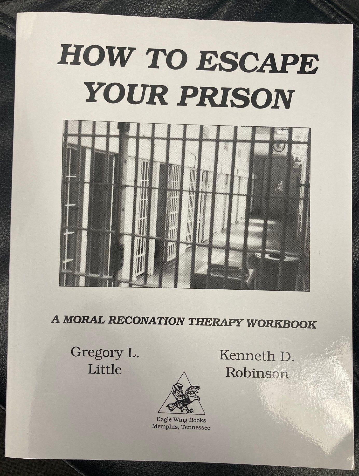 a picture of a prison sell on a book page titled a moral rconation therapy workbook