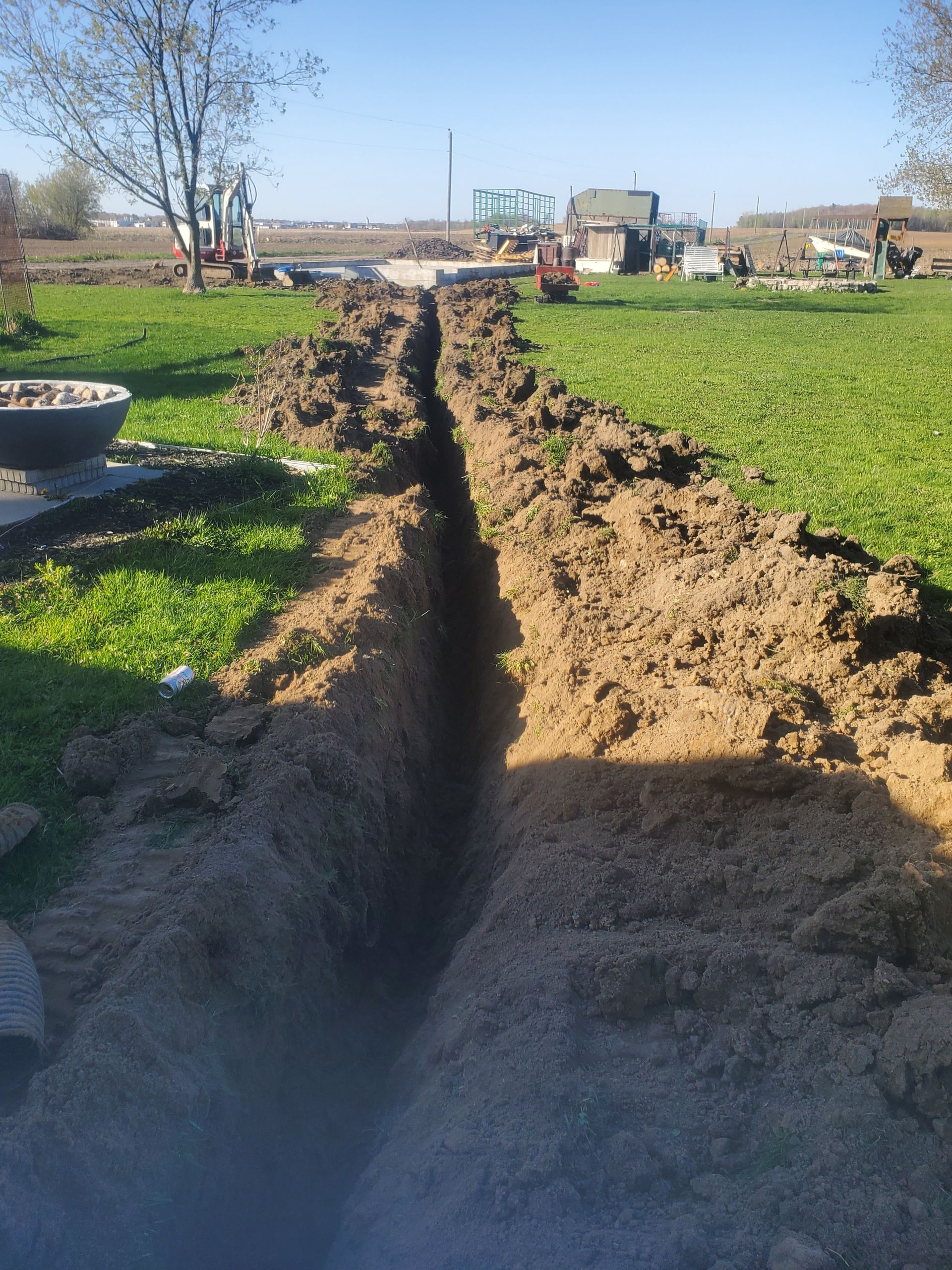 A large trench in the middle of a grassy field