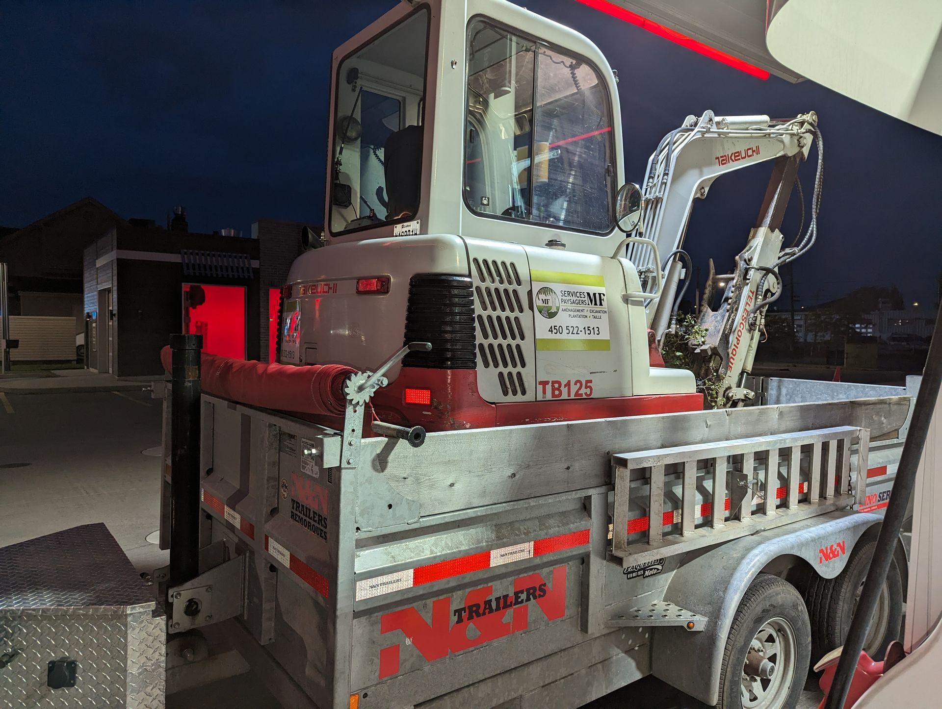 An excavator is parked on the back of a trailer.