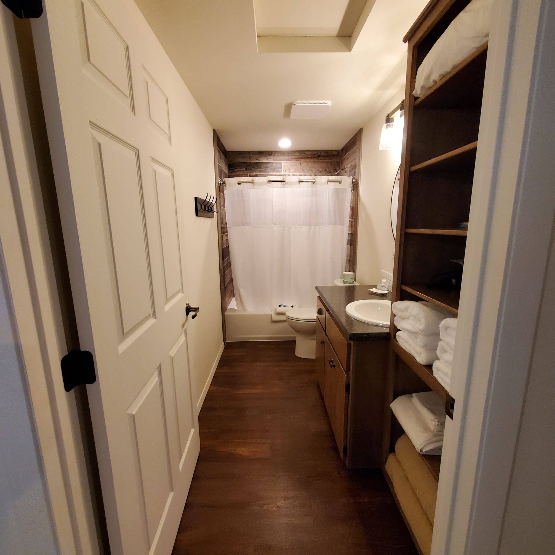 A bathroom with a toilet a sink and a shower curtain
