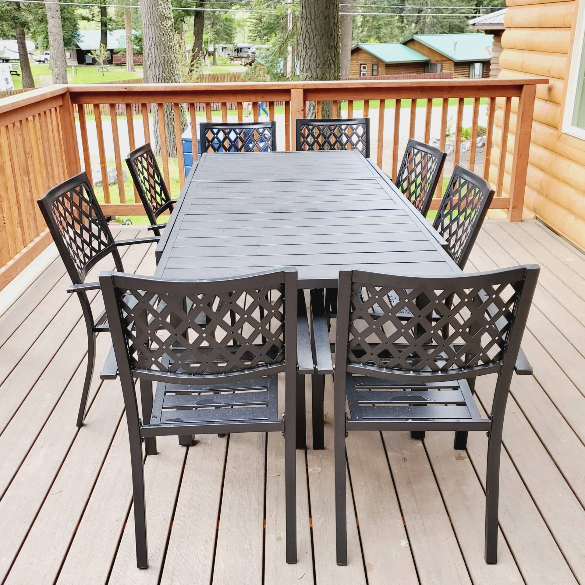 A wooden deck with a table and chairs on it