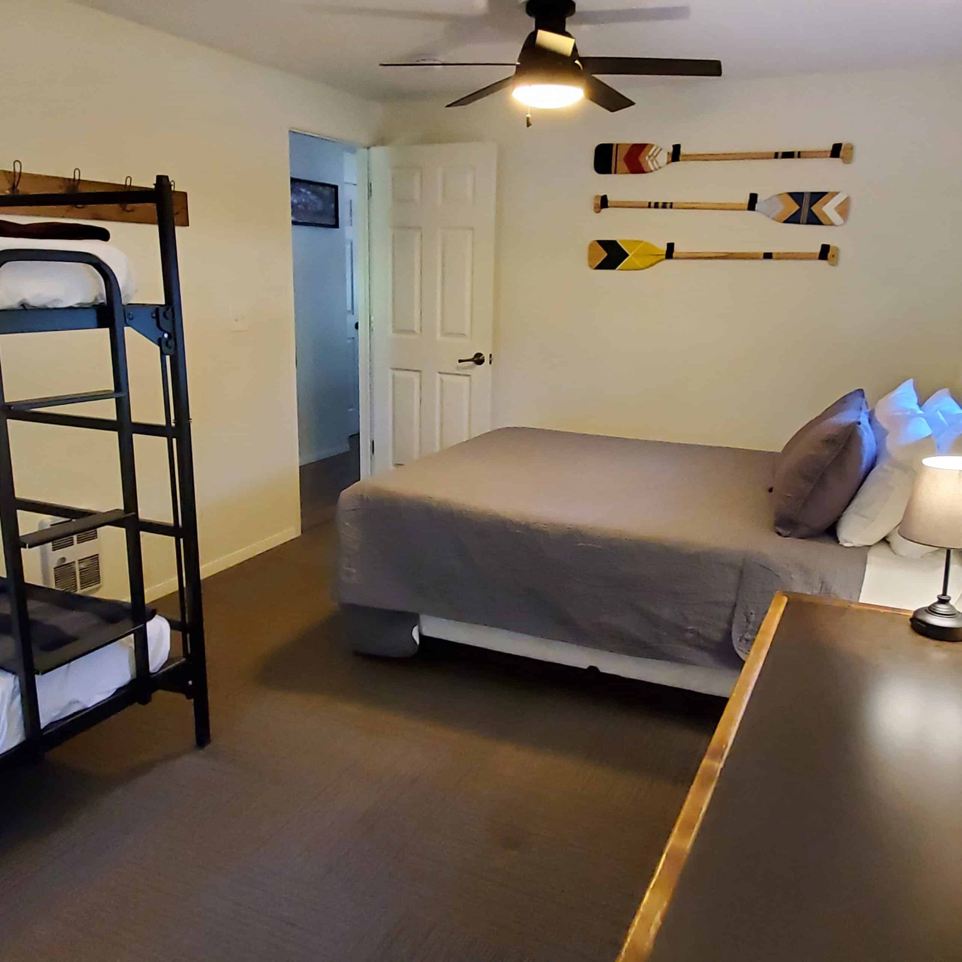 A bedroom with a bunk bed and a ceiling fan