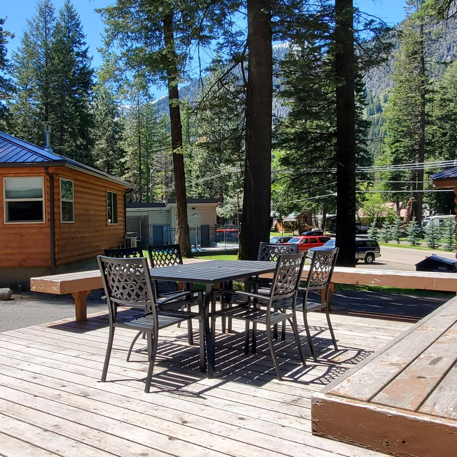 A wooden deck with a table and chairs on it