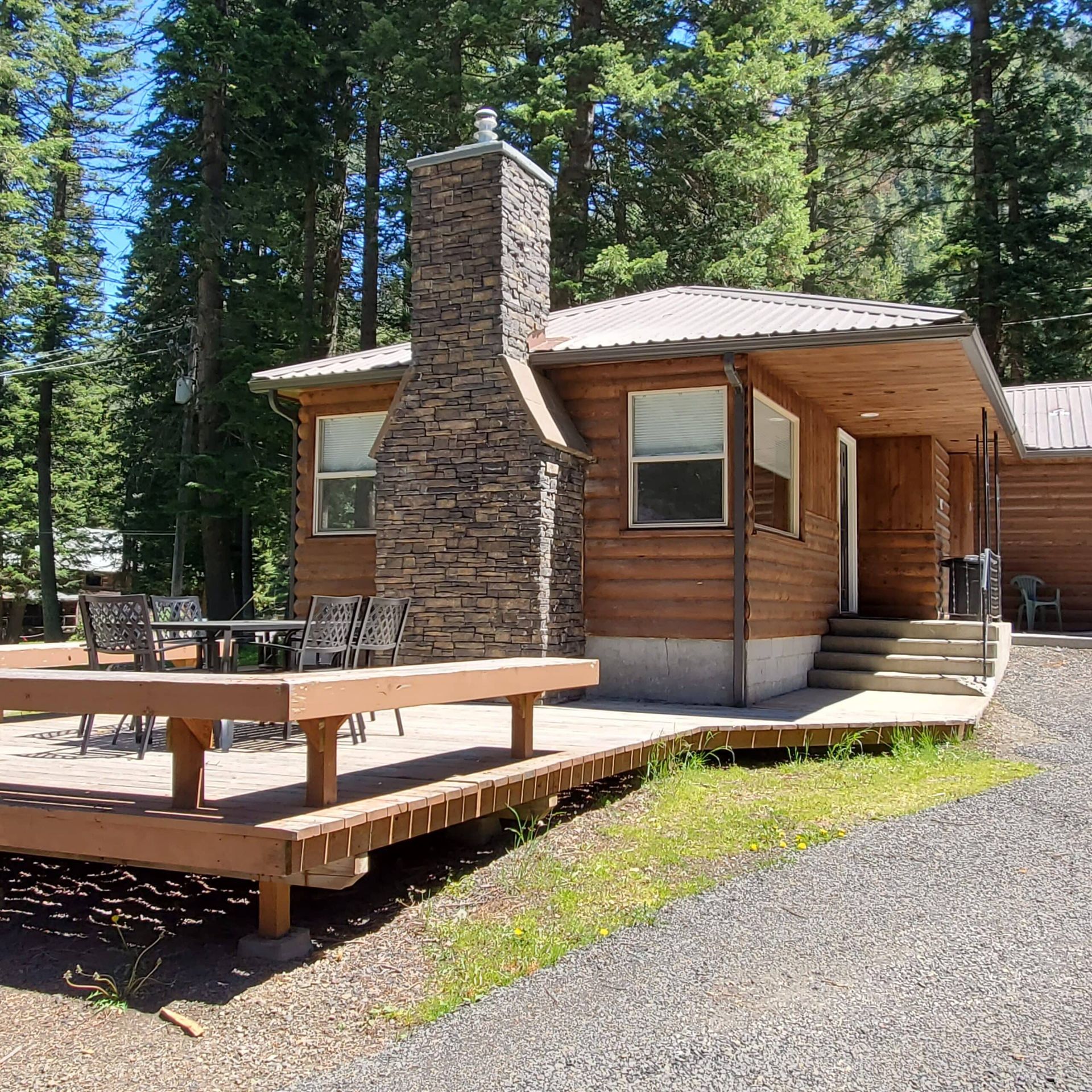 A small wooden cabin with a stone chimney