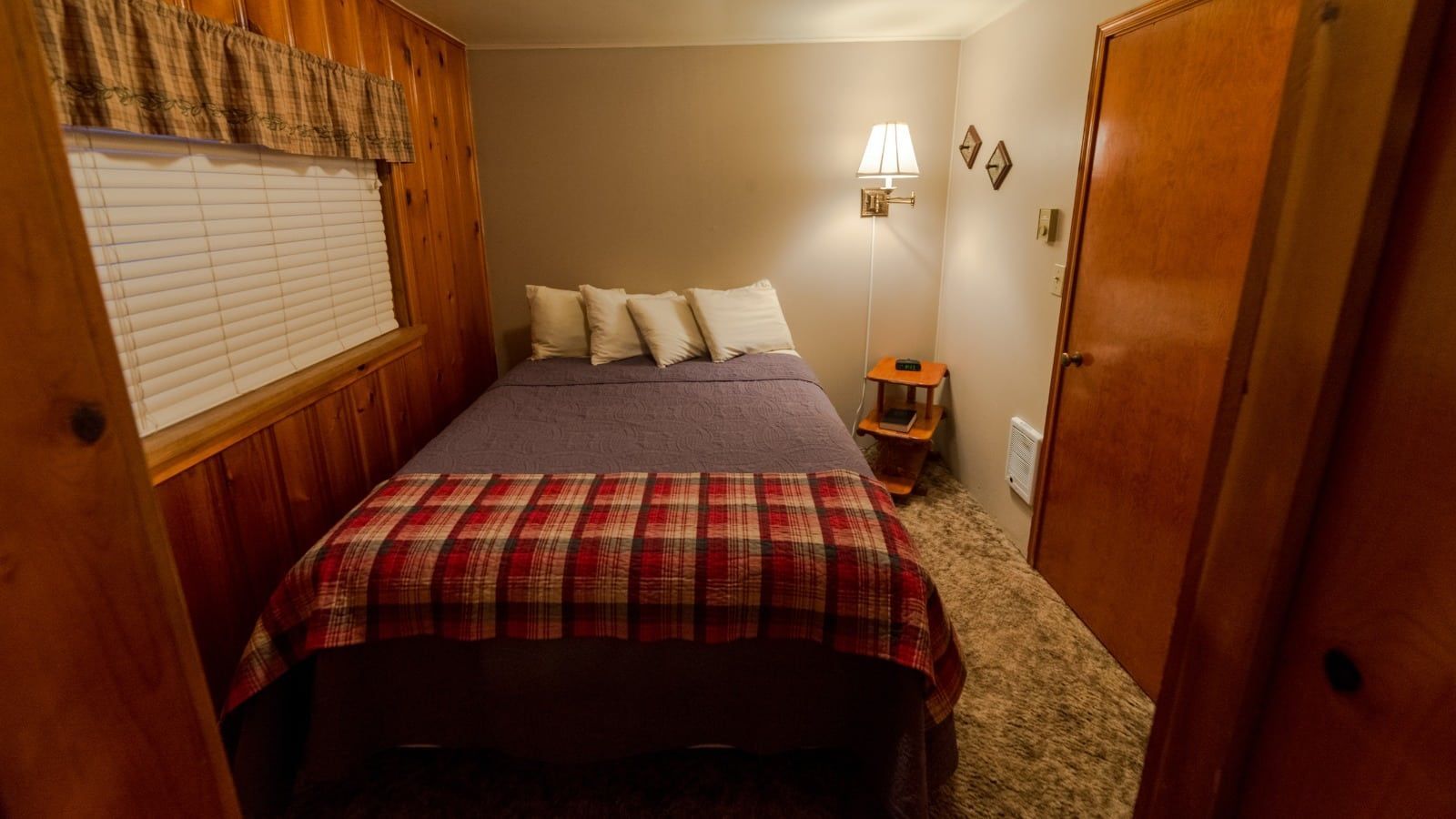 A bedroom with a bed and a window.