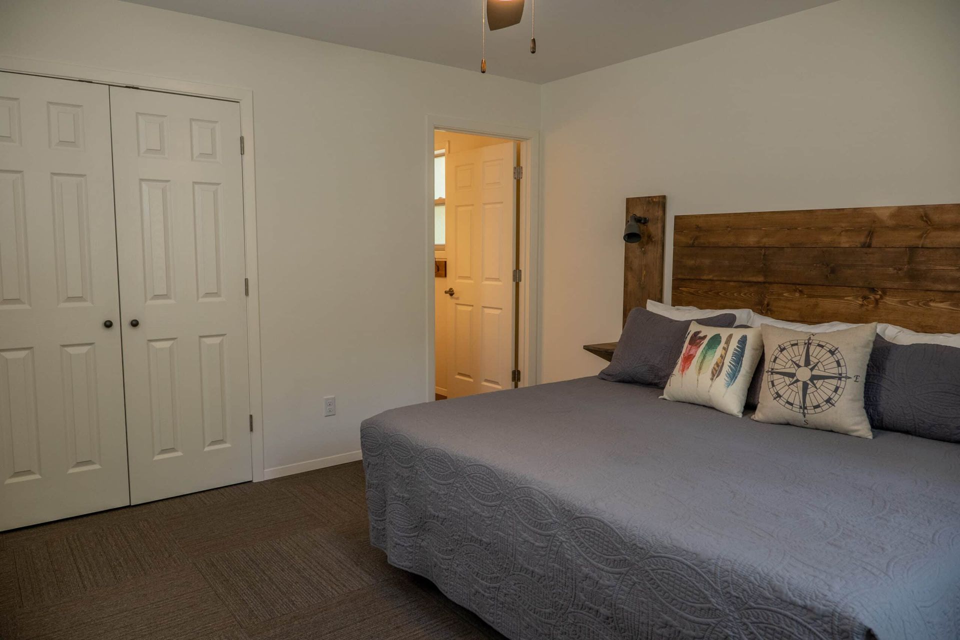 A bedroom with a king size bed and a wooden headboard.