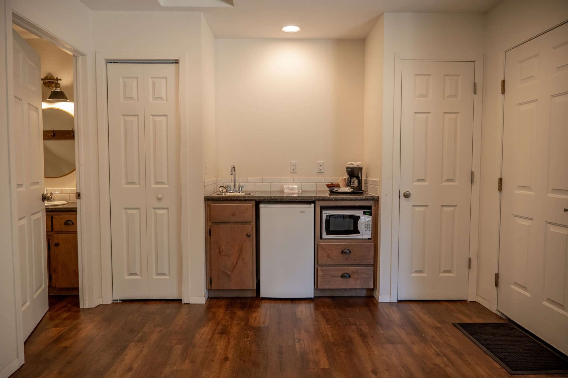 A kitchen with a sink , microwave , refrigerator and dishwasher.