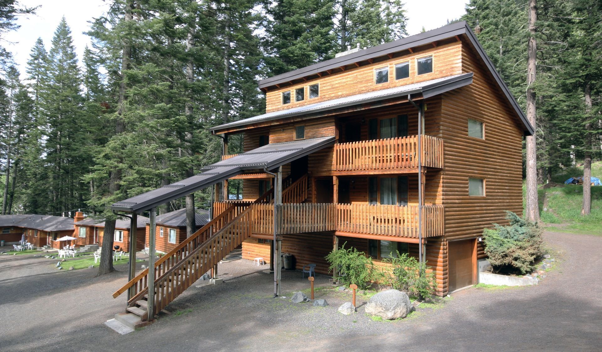A large wooden house with stairs leading up to it