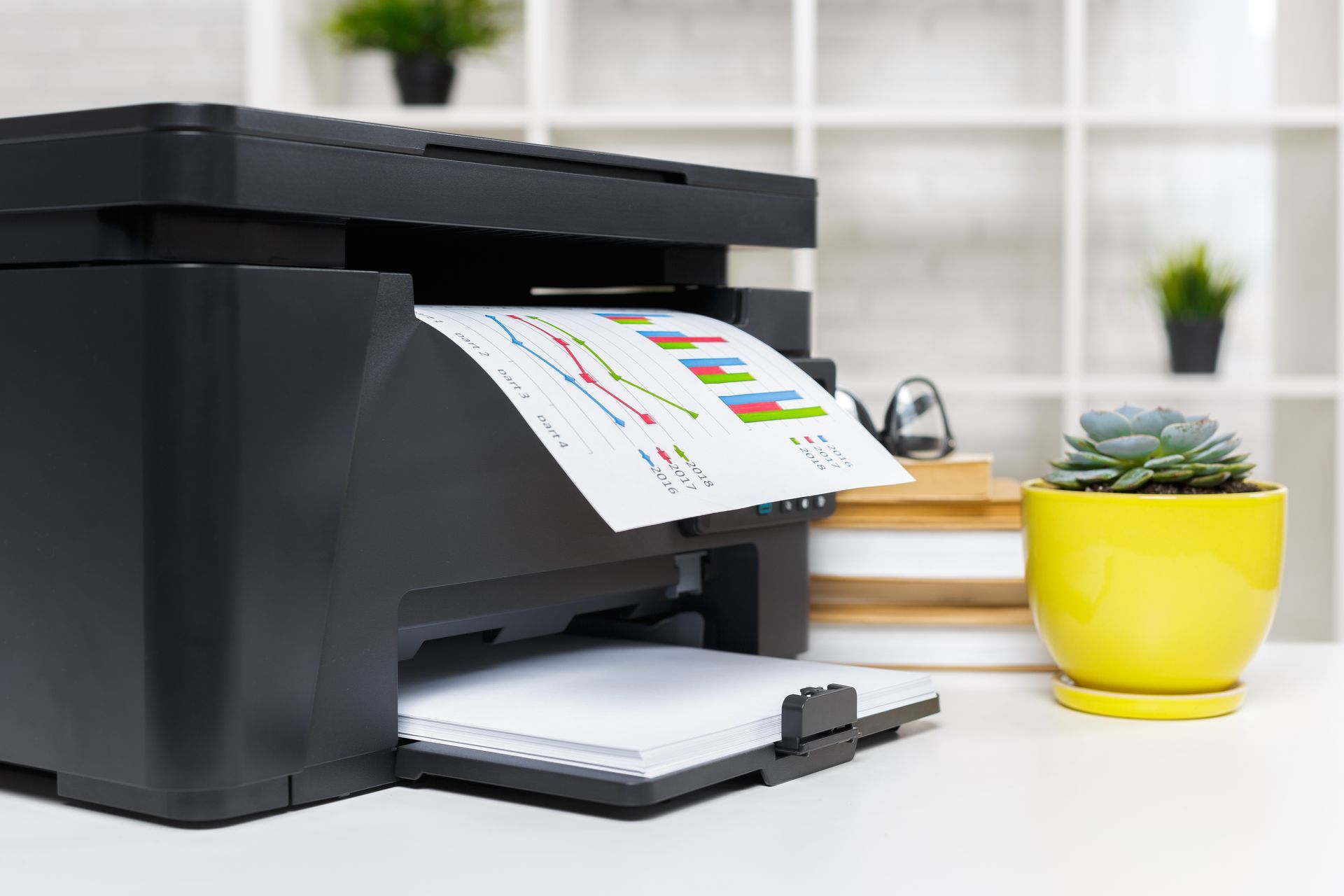 A printer is printing a piece of paper on a desk.