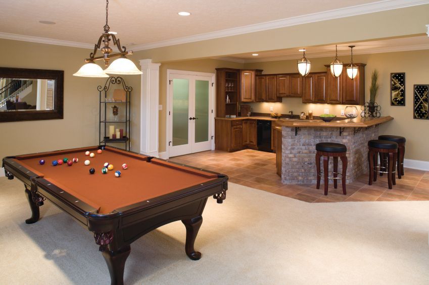 Pool room with pool table, bar, and decorative lighting.