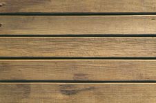 Wooden deck planks, brown with horizontal grooves.