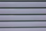 Light-blue horizontal slats, likely part of a window blind or wall paneling, with subtle shadows.