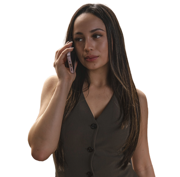 A woman in a vest is talking on a cell phone
