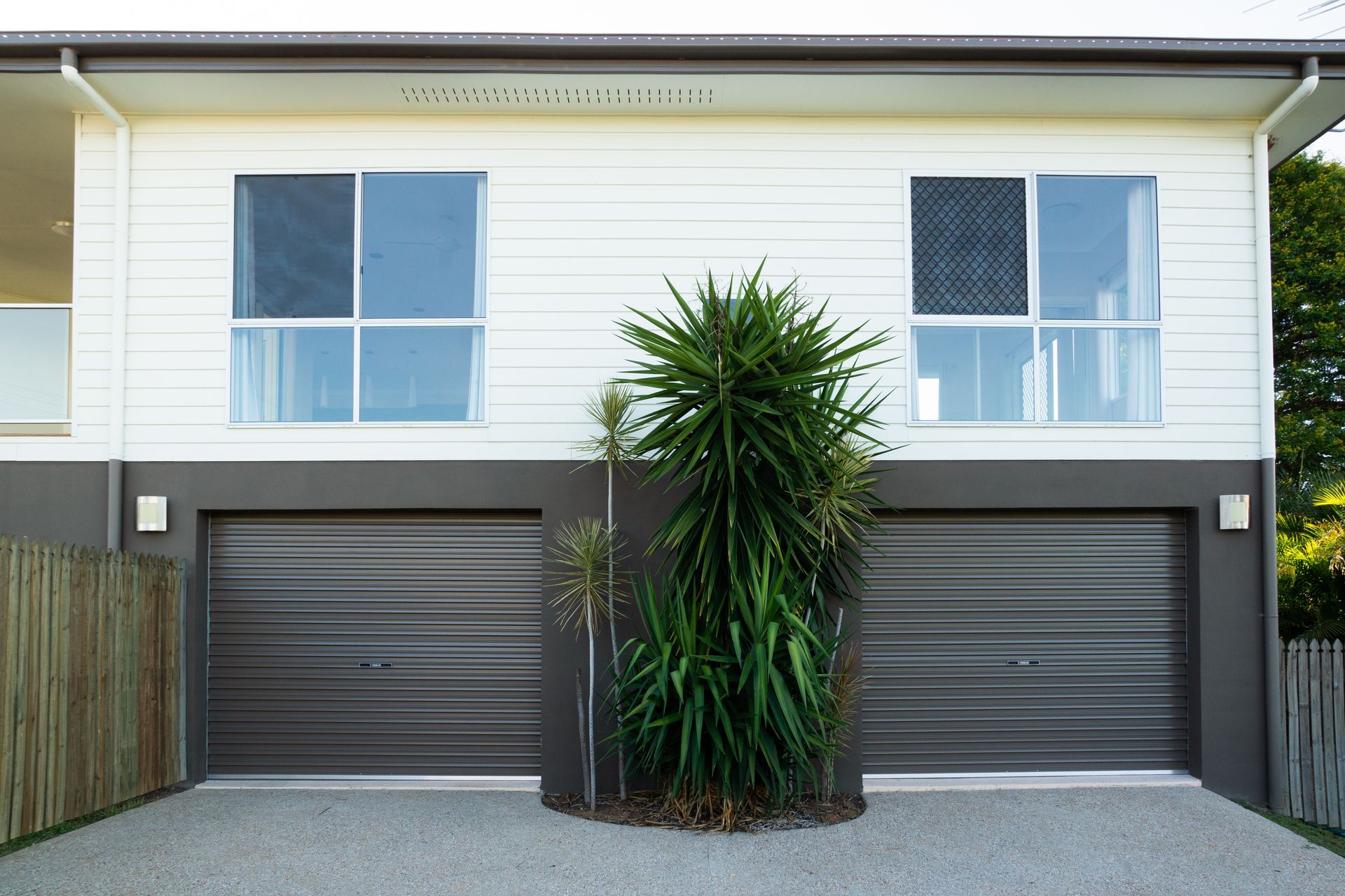 Front view of an Australian two-storey home with two garage doors side by side.