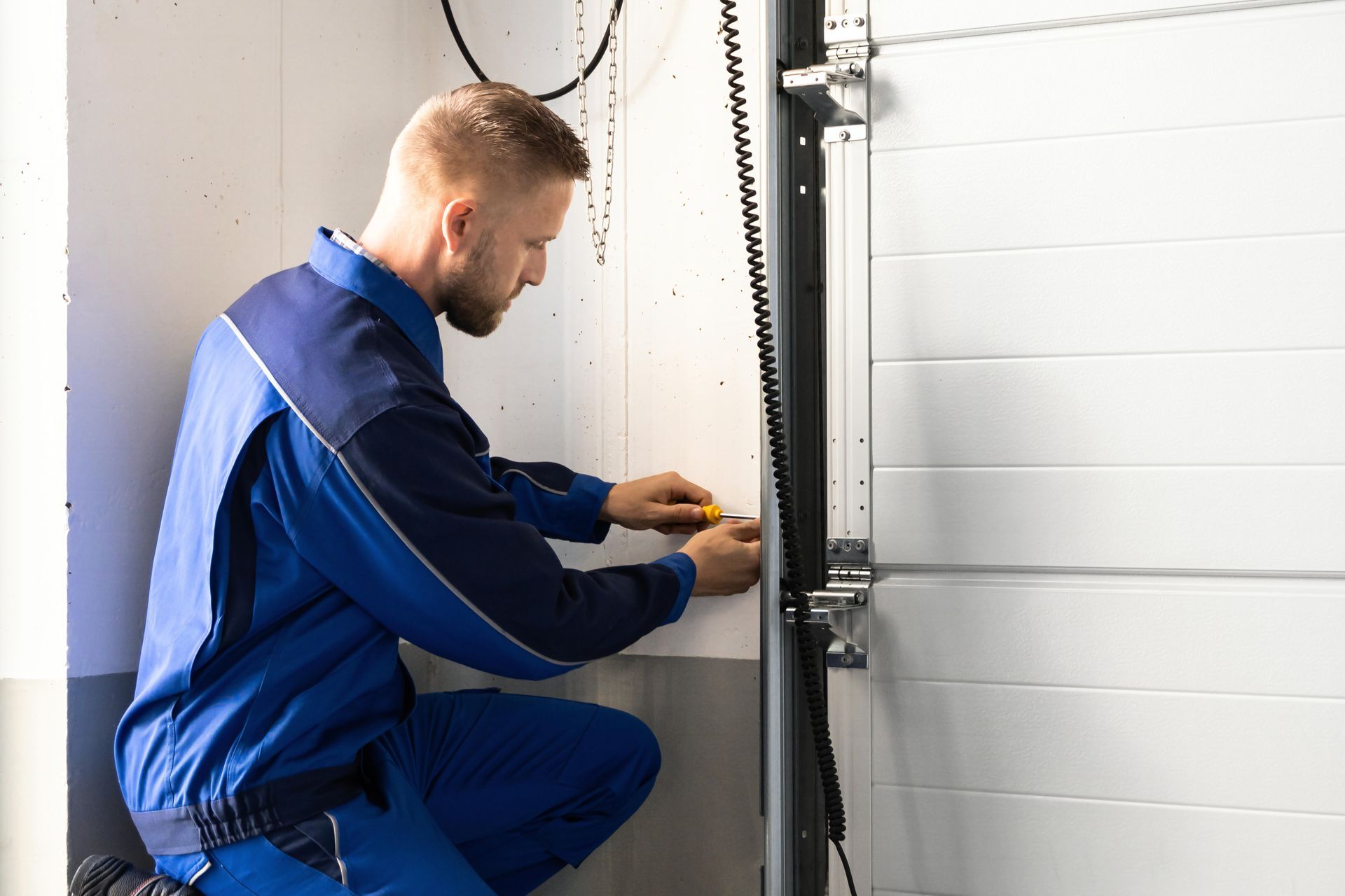 Garage door installation and repair at home by a technician. Garage door installation and repair at home by a technician.