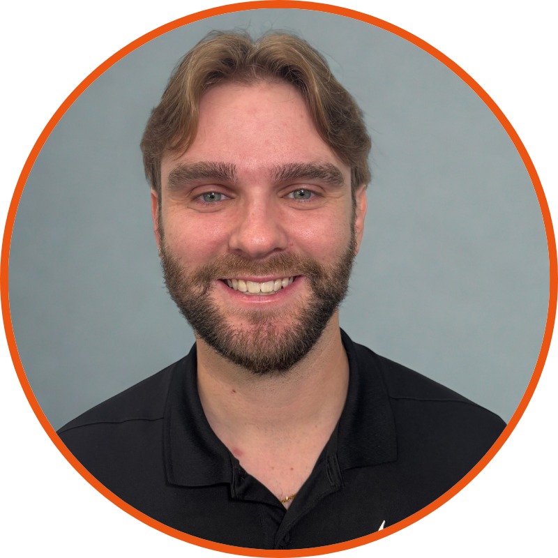A man in a polo shirt is smiling for the camera