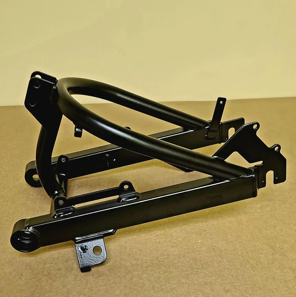 A black steel motorcycle swingarm and rear subframe assembly against a beige background.