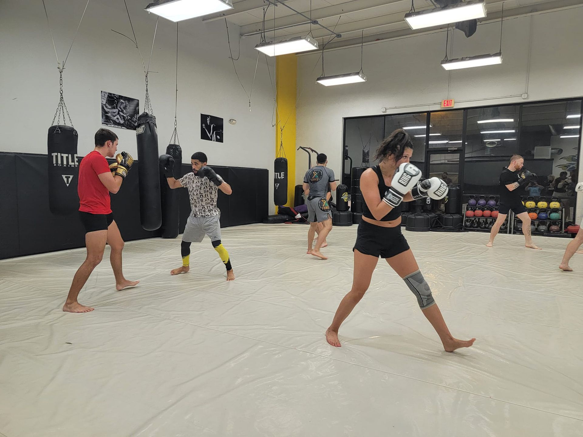 A group of people are boxing in a gym.