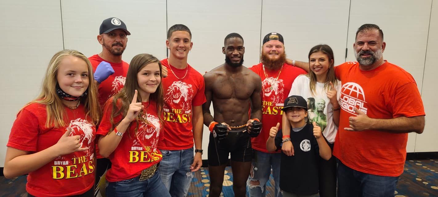 A group of people are posing for a picture with a boxer.