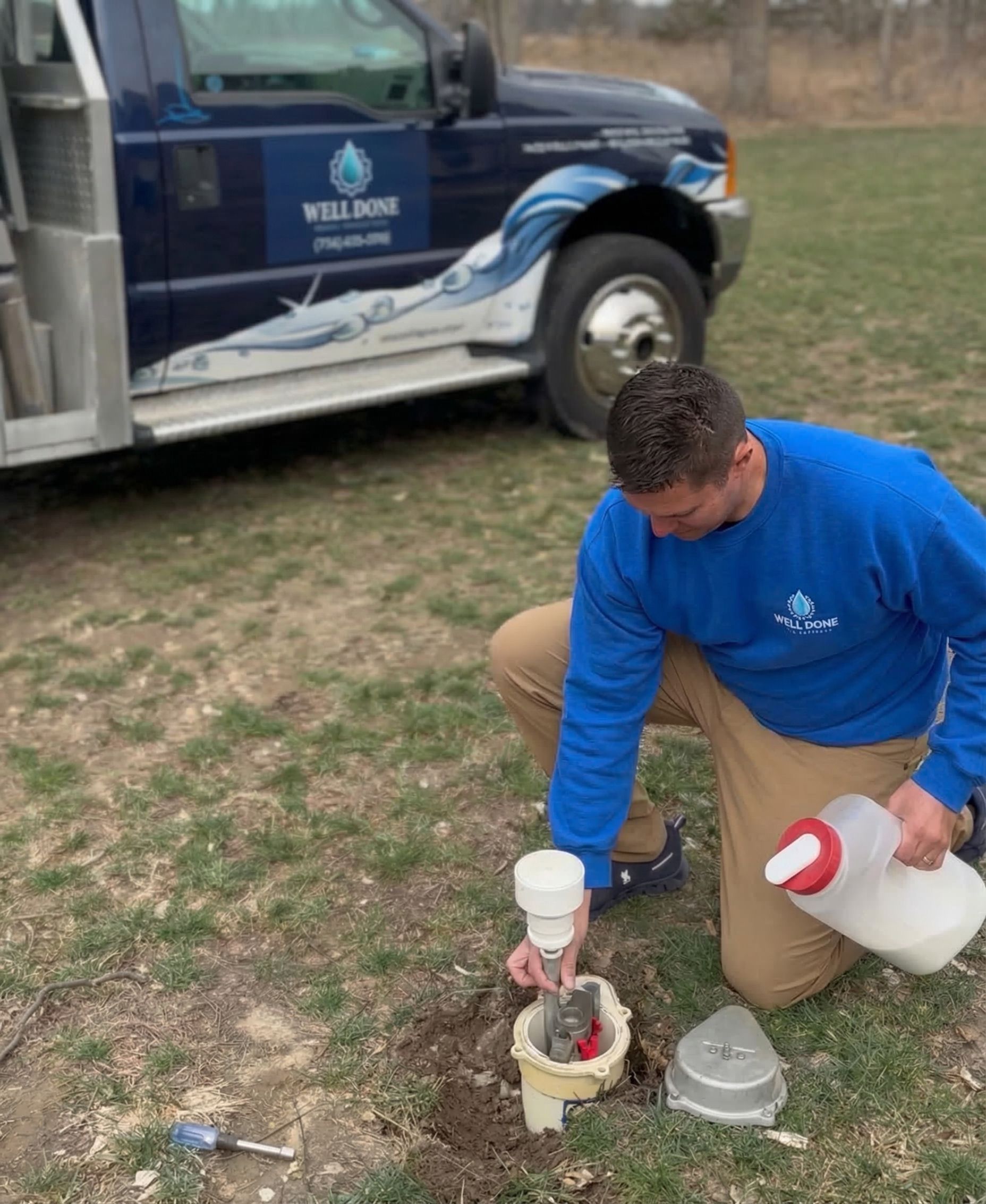 Travis Ostrowski | Well pump technician standing beside Well Done Well Services truck in Grass Lake Michigan