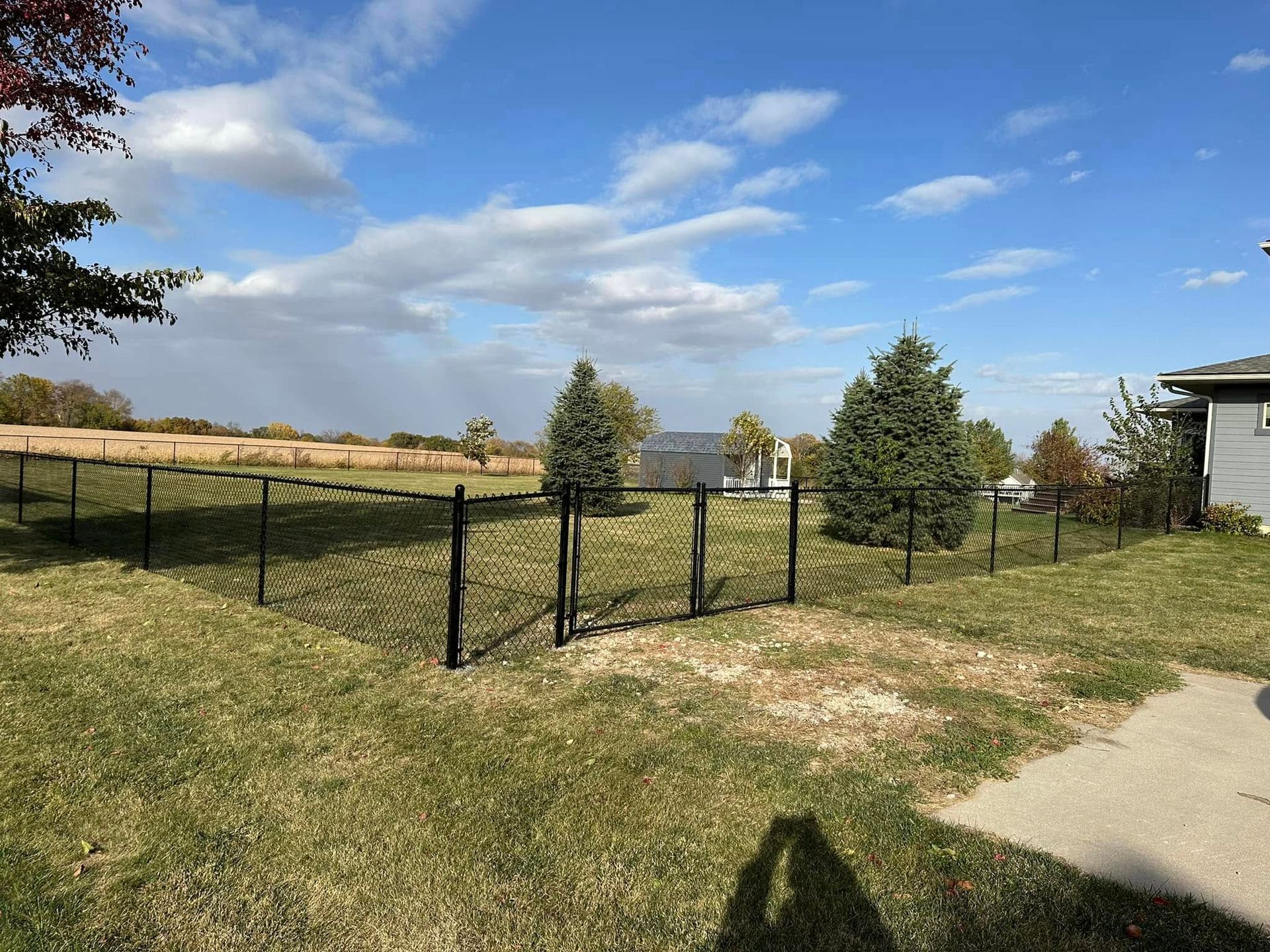 chain link fence and wooden privacy fence surrounding a residential backyard