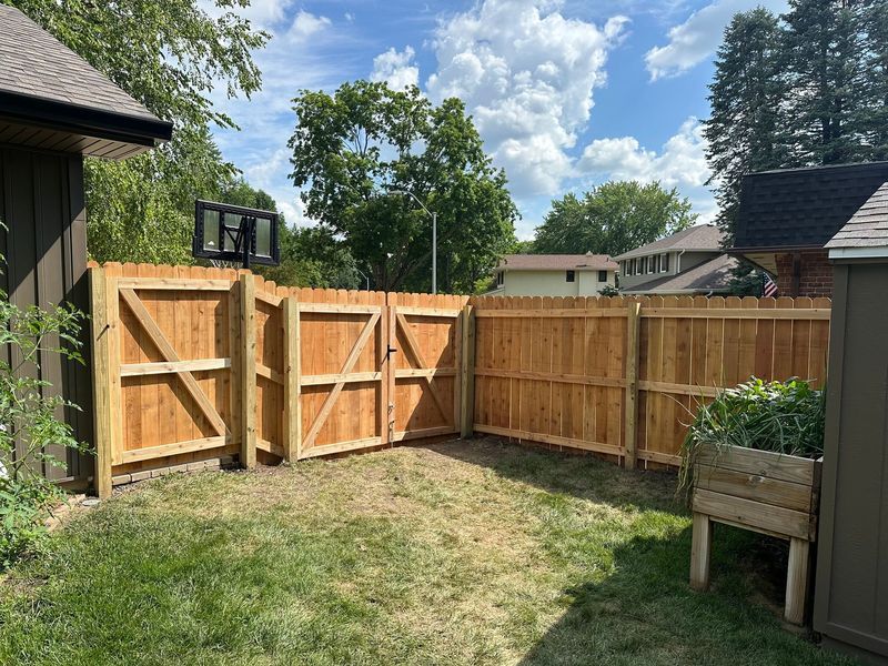 Backyard in Ames, IA with a wooden privacy fence