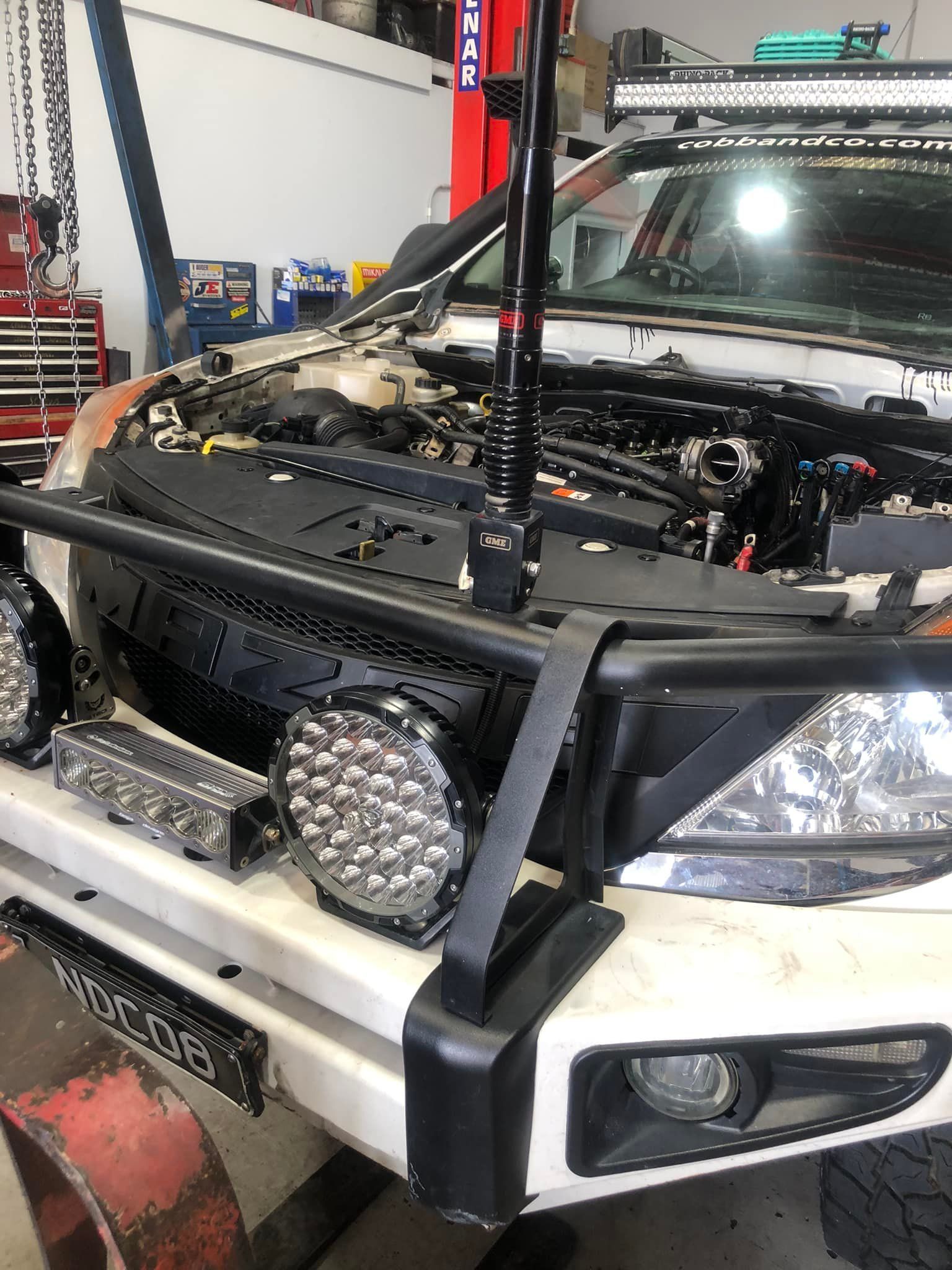 White Off-road Vehicle With Lights and Bumper in a Workshop — Diesel Engine Rebuilding Australia in Gold Coast, QLD