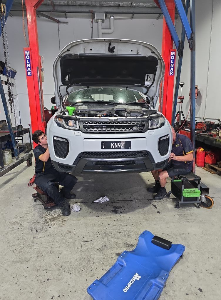 Two Mechanics Working on a White Range Rover in a Garage — Diesel Engine Rebuilding Australia in Gold Coast, QLD