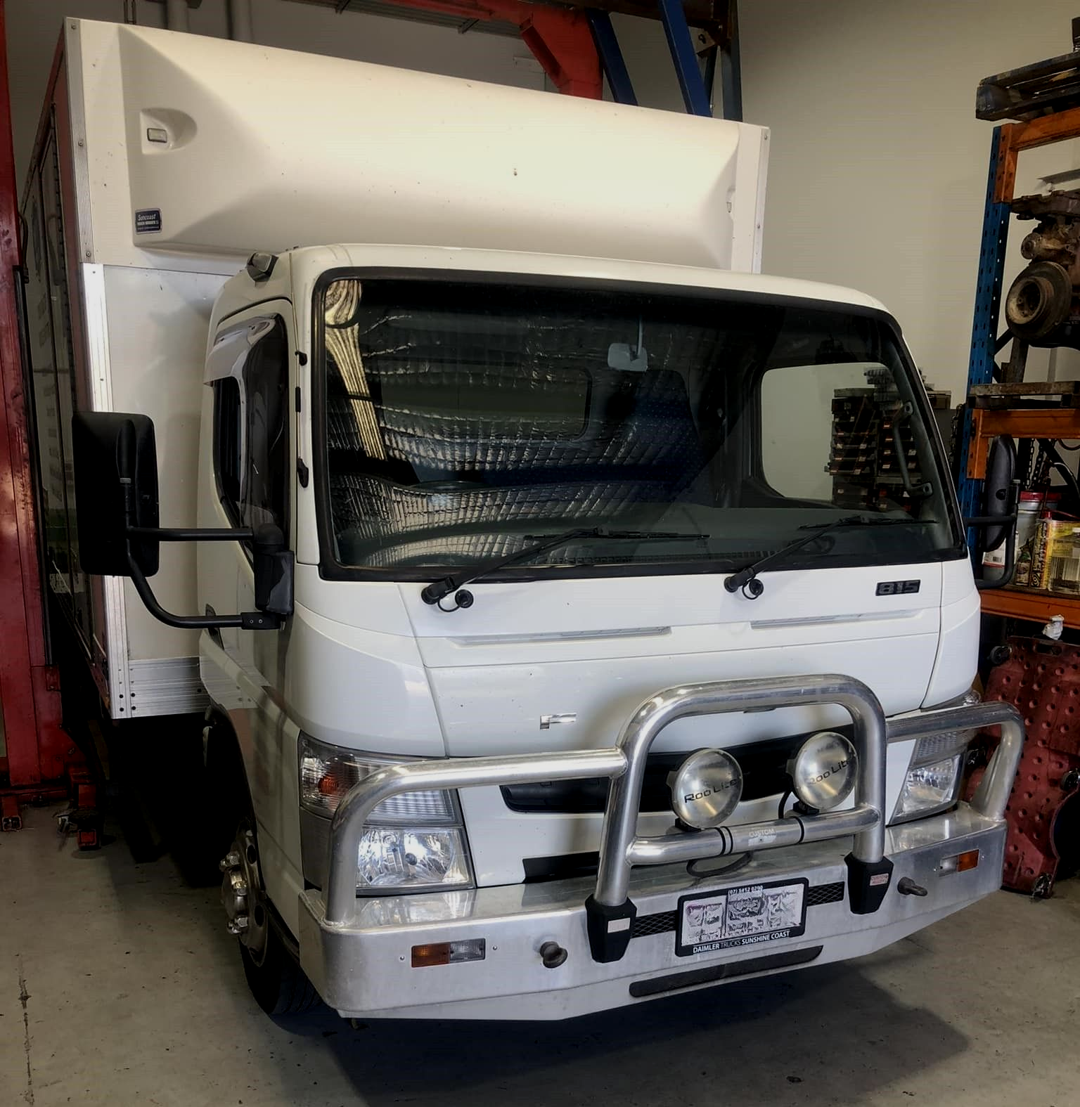 White Truck With A Cargo Box In A Workshop  — Diesel Engine Rebuilding Australia in Gold Coast, QLD