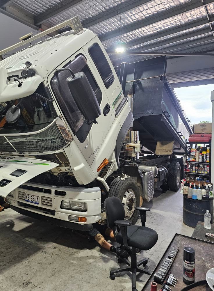 White Dump Truck Being Repaired In A Shop — Diesel Engine Rebuilding Australia in Gold Coast, QLD