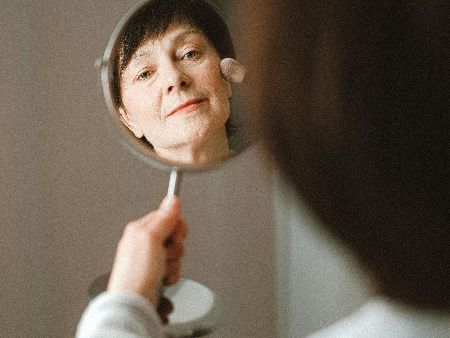 Woman looking at herself in a mirror