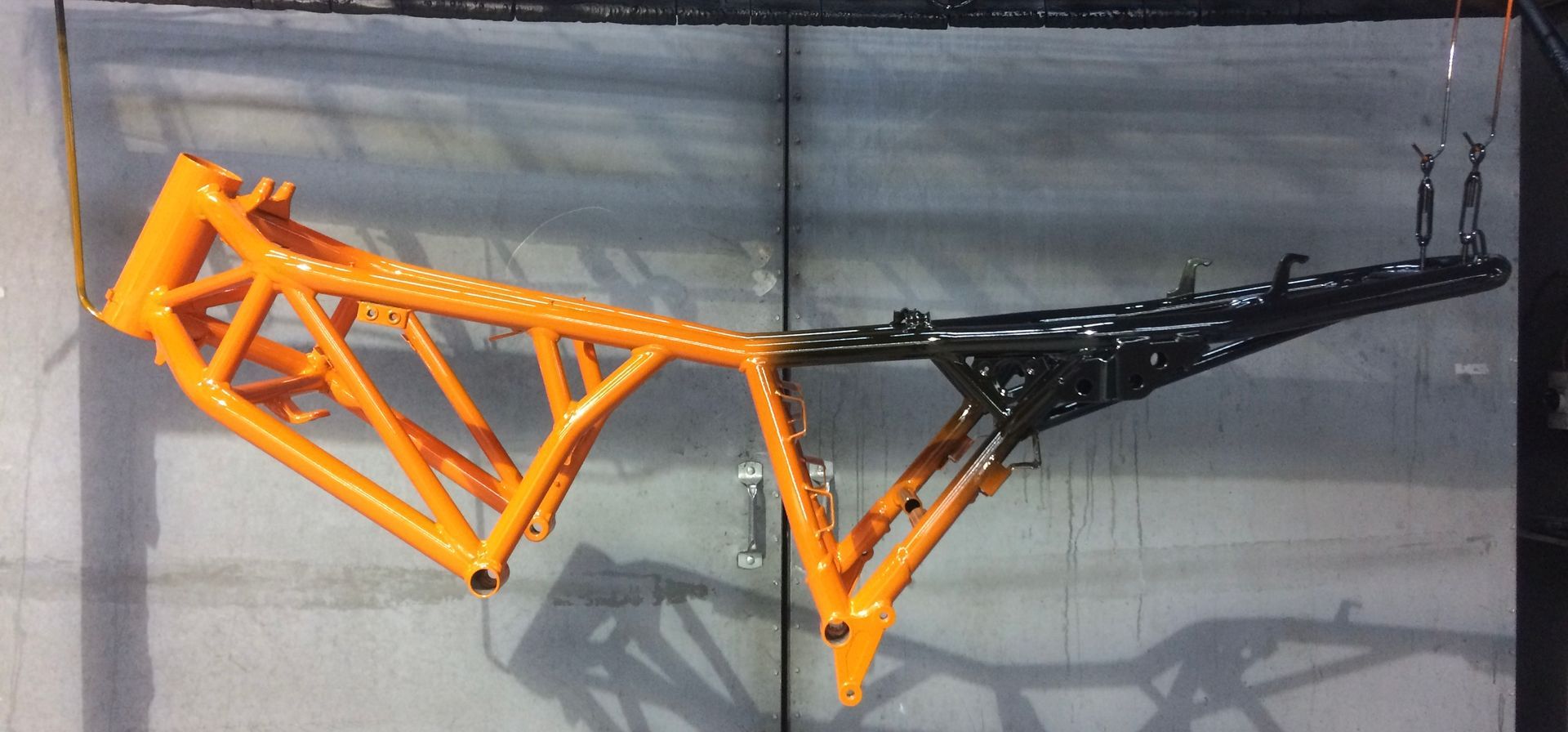 A picture of a motorcycle frame painted orange and black