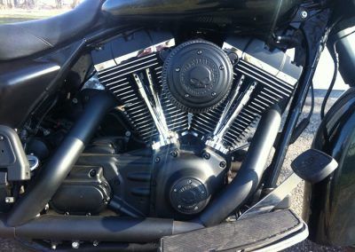 A black harley davidson motorcycle is parked on the side of the road