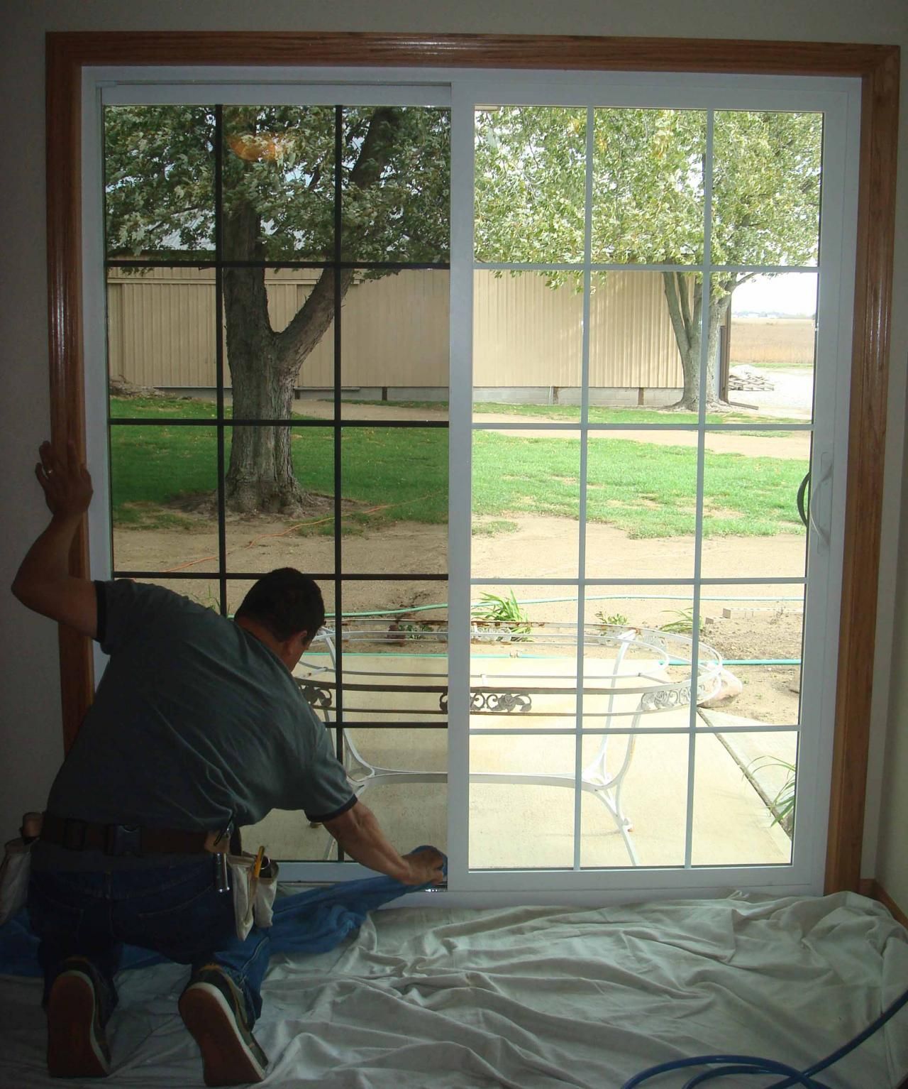 A man is installing a sliding glass door