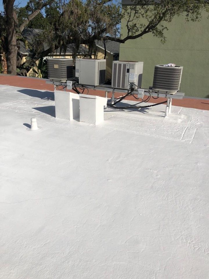 A white roof with a lot of air conditioners on it — Tampa, FL — Bill Shields Roofing