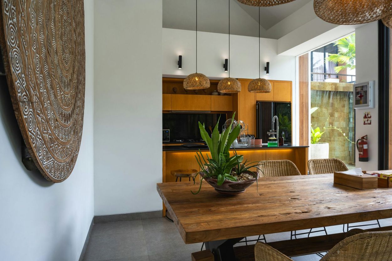 There is a wooden table in the middle of the room.