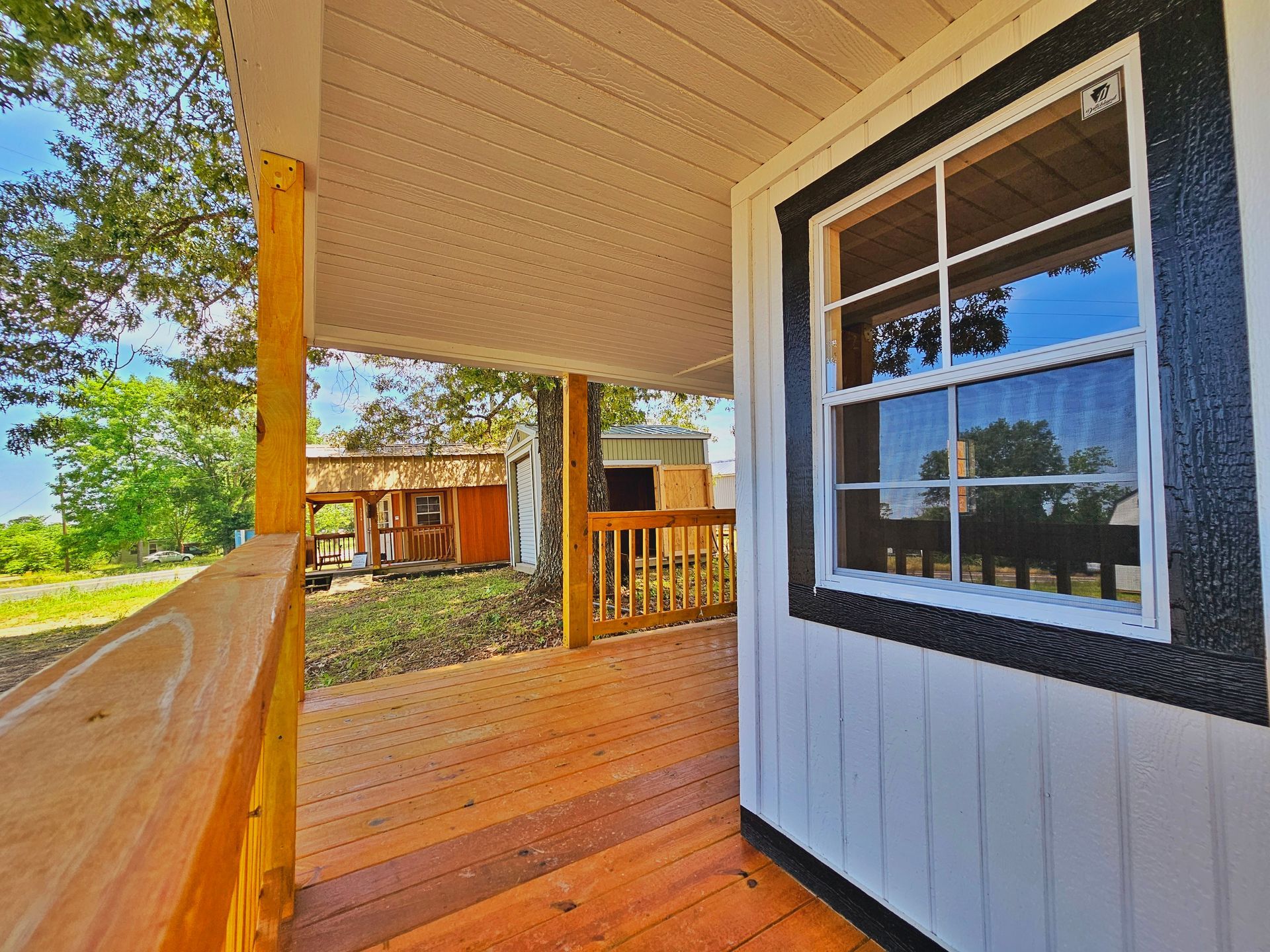 A small house with a porch and a window.
