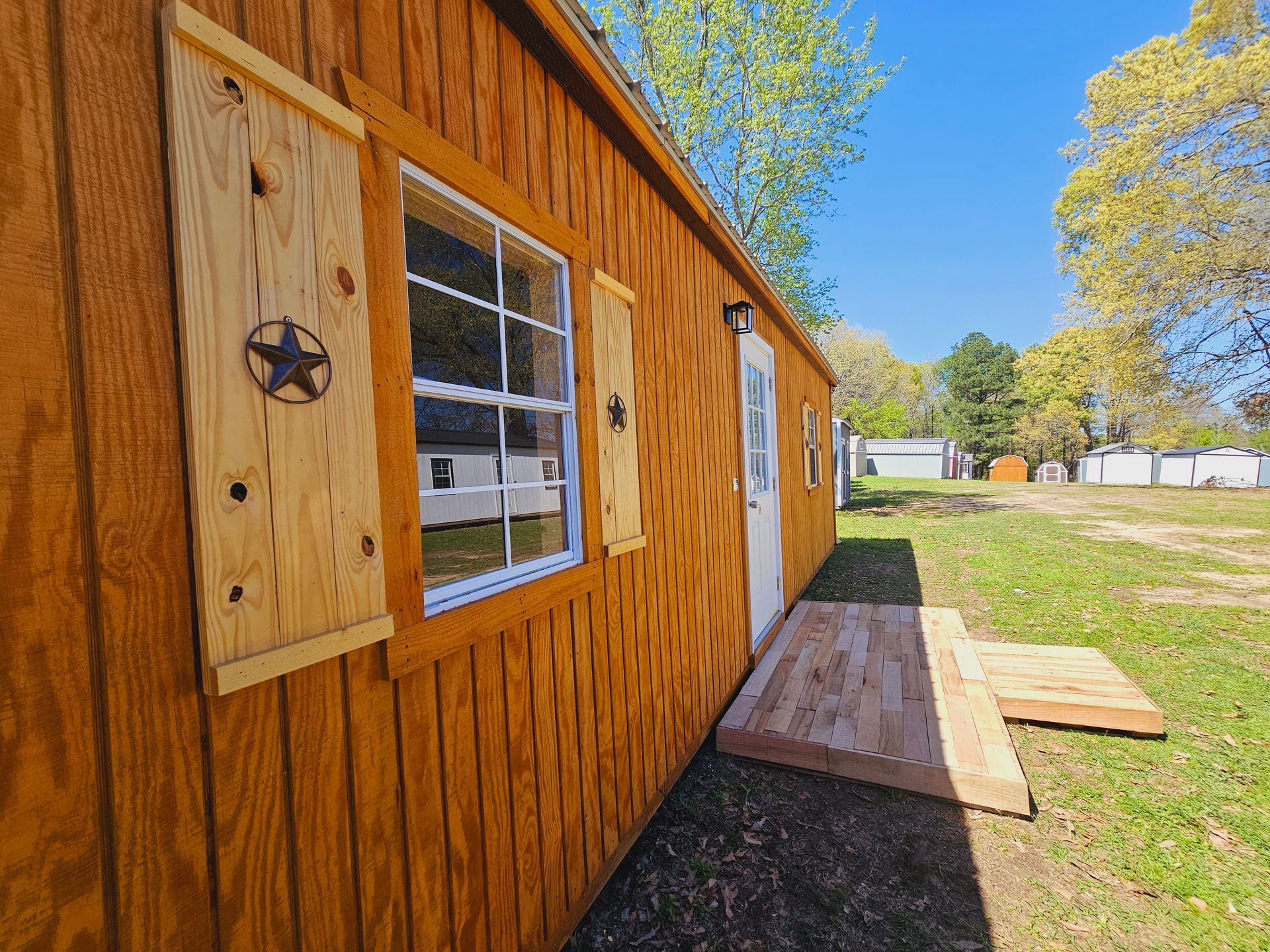 A wooden shed with a star on the side of it.