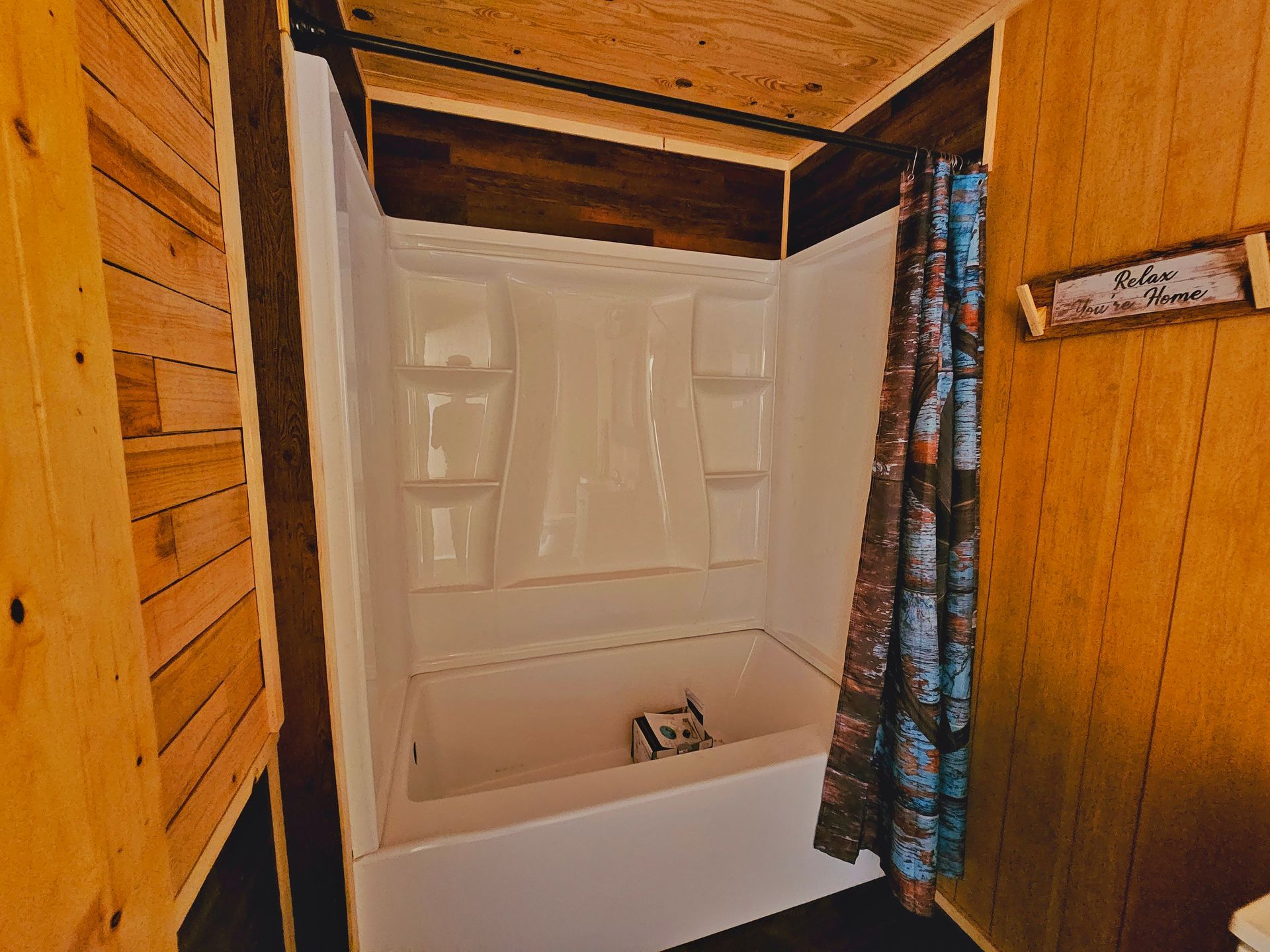 A bathroom with a bathtub and shower stall.