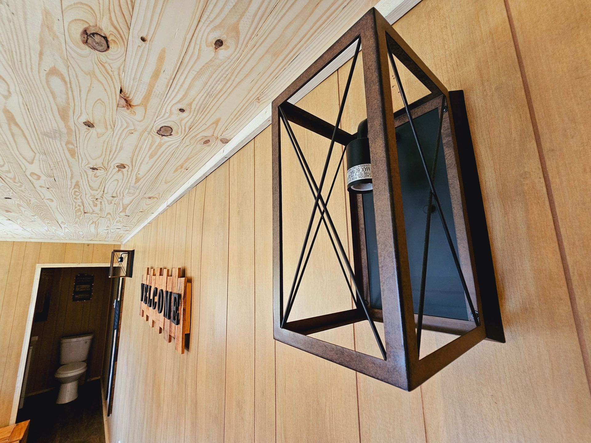 A wooden wall with a lantern hanging from it