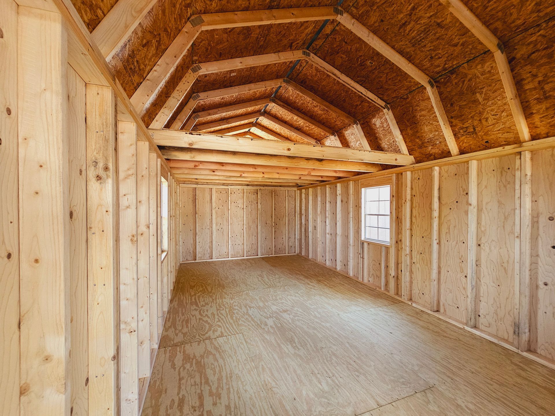 An empty room with wooden walls and a wooden floor.