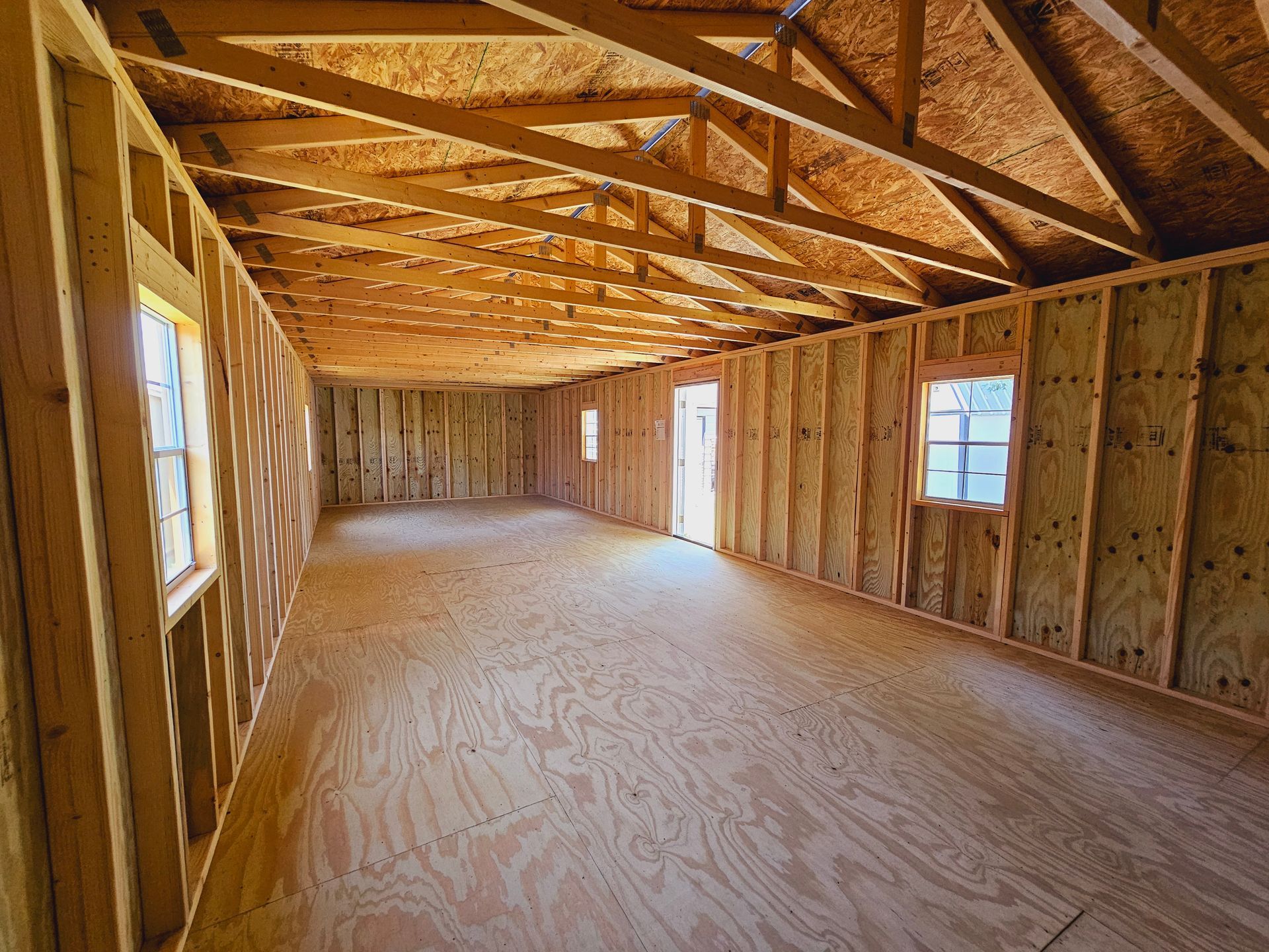 An empty room with wooden walls and a wooden floor